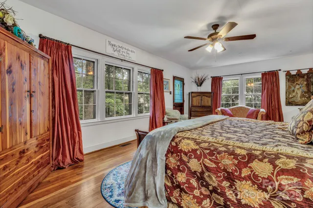a bed sitting in a bedroom next to a window