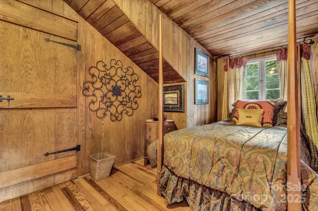 a bed sitting in a bedroom next to a window