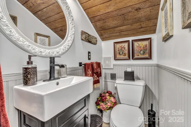 a bathroom with a sink a mirror and a toilet