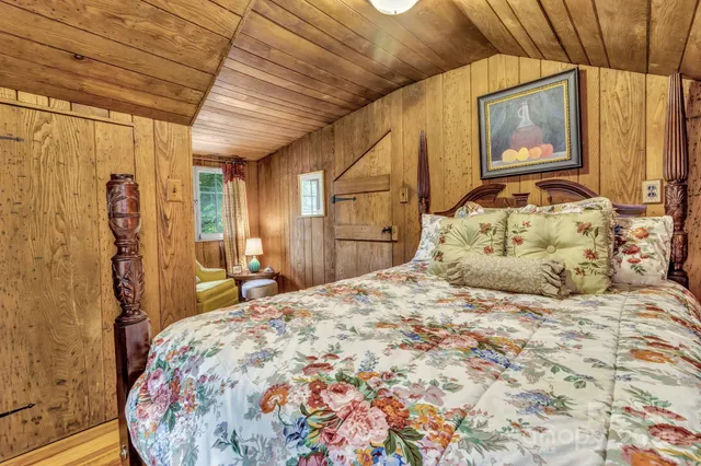 a bedroom with a bed and a painting on the wall