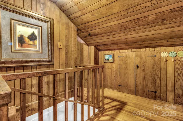 a view of a bathroom with wooden floor and a window