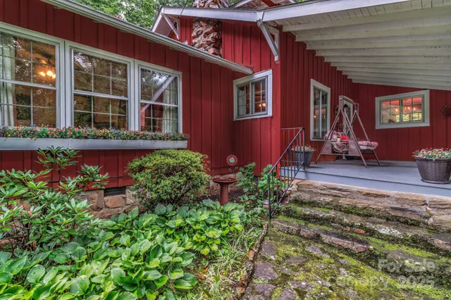 a view of a house with many windows and flower plants