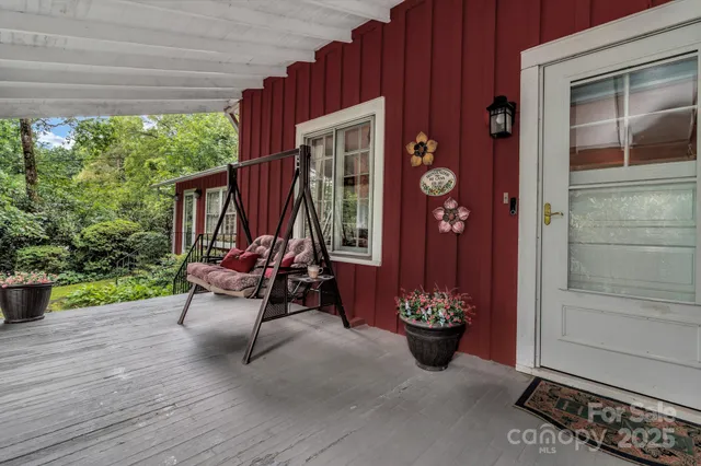 a view of a deck with table and chairs and potted plants