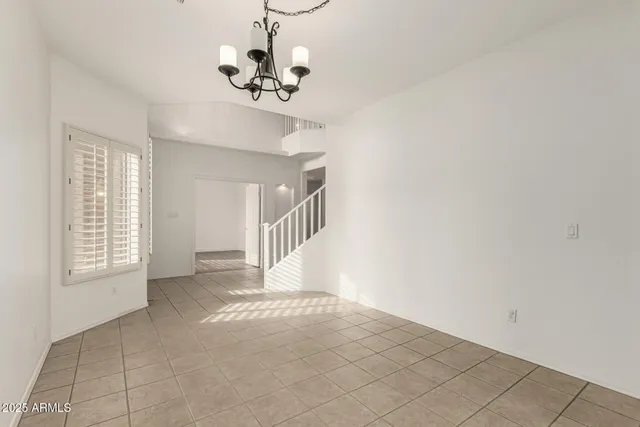 an empty room with a ceiling fan and a window