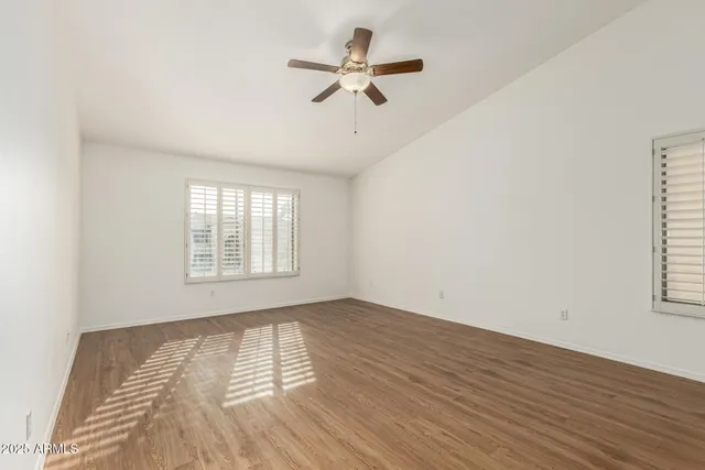 a view of an empty room with a fireplace and a window