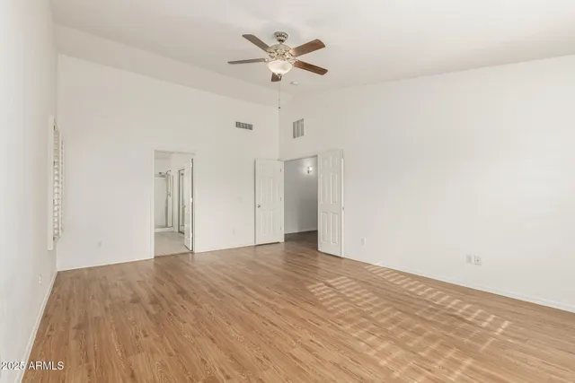 wooden floor fireplace and windows in an empty room