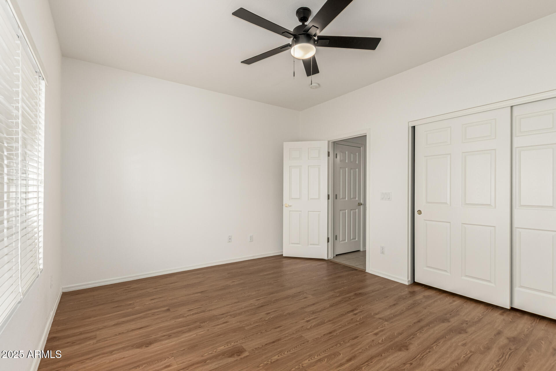 2978 East Ranch Court Gilbert, AZ 85296 - Photo 32 of 72 an empty room with wooden floor ceiling fan and windows