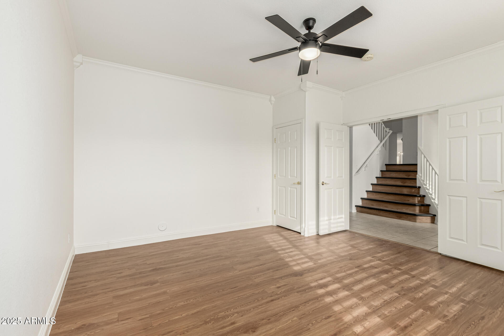 2978 East Ranch Court Gilbert, AZ 85296 - Photo 40 of 72 a view of an empty room with wooden floor and a ceiling fan