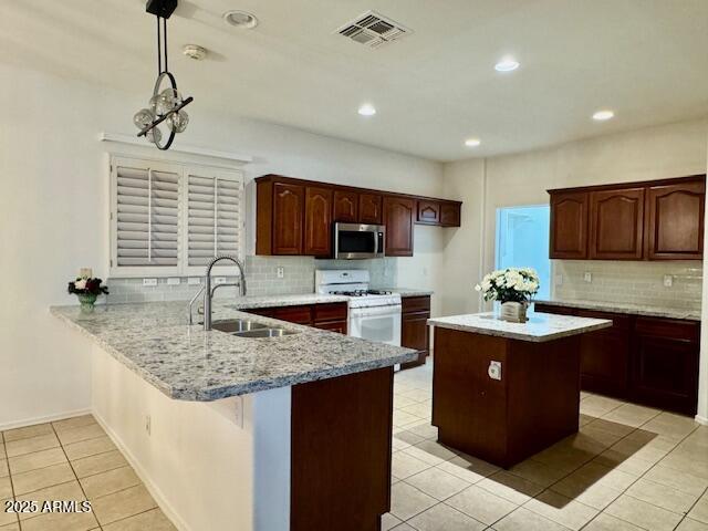 2978 East Ranch Court Gilbert, AZ 85296 - Photo 54 of 72 a kitchen with granite countertop a sink and a stove
