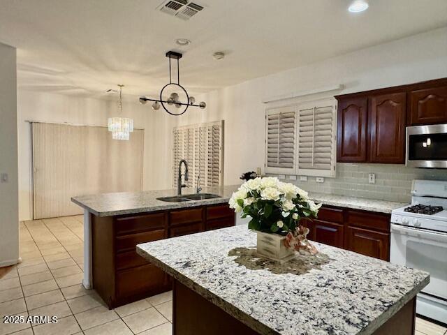 2978 East Ranch Court Gilbert, AZ 85296 - Photo 55 of 72 a kitchen with stainless steel appliances granite countertop sink wooden cabinets and a counter top space
