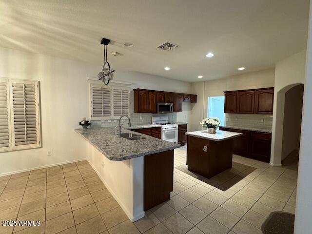 2978 East Ranch Court Gilbert, AZ 85296 - Photo 57 of 72 a kitchen with stainless steel appliances granite countertop a sink counter space cabinets and a window