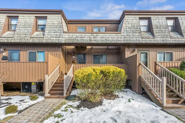 a view of a blue house with large windows