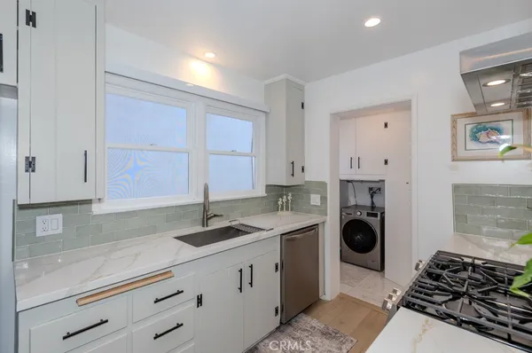 a kitchen with granite countertop a sink and a stove