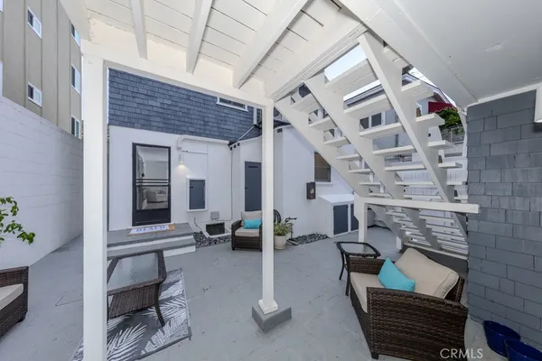 a bedroom with a bed couch and window