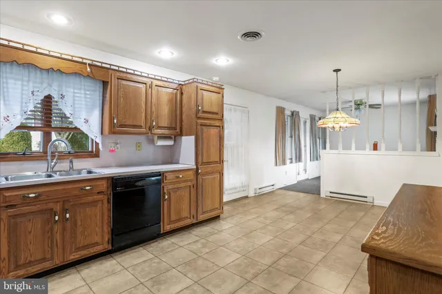 a kitchen with stainless steel appliances granite countertop a sink and cabinets