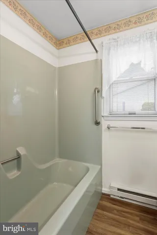 a bathroom with a bathtub and a shower