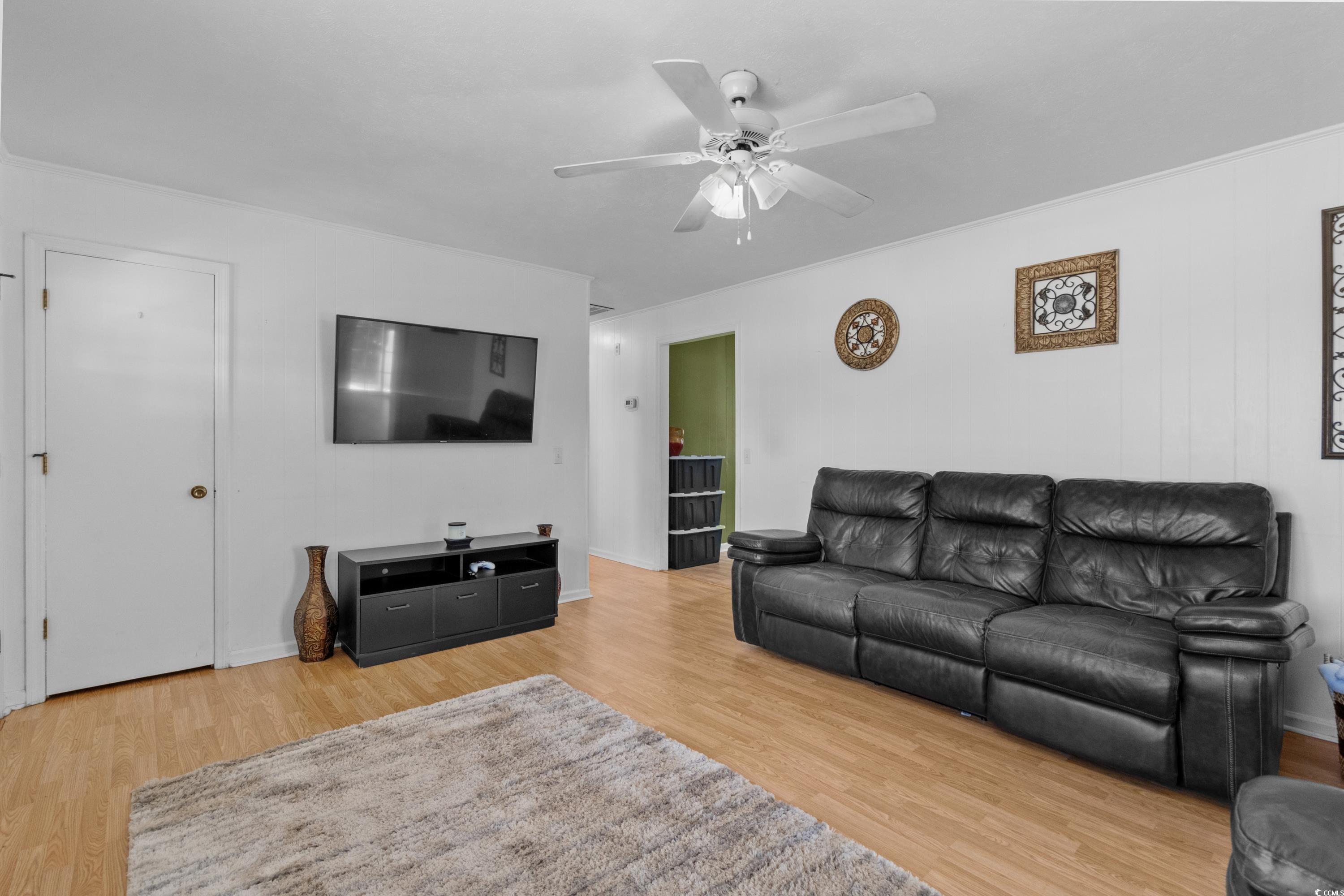 140 Flag Patch Road Loris, SC 29569 - Photo 7 of 38 Living area with ceiling fan and wood finished flo
