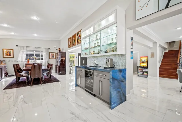 a large kitchen with stainless steel appliances granite countertop a stove a sink and a refrigerator