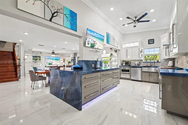 a kitchen with stainless steel appliances granite countertop a stove a sink and a refrigerator