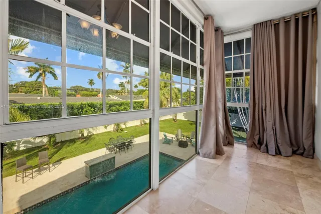a living room with a bed furniture and a large window