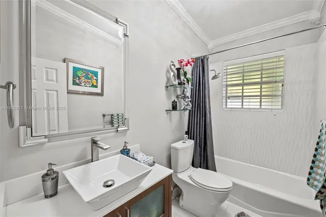a bathroom with a granite countertop sink a toilet and shower