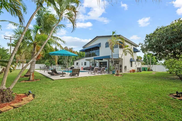 a view of a swimming pool with a yard