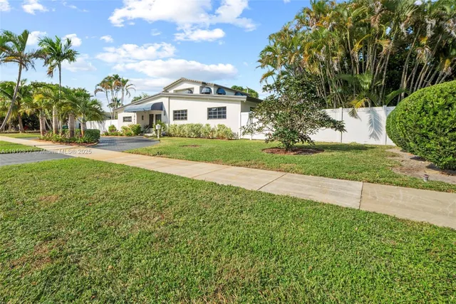 a living room with furniture and a pool table