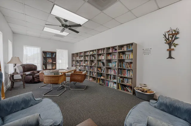 a kitchen with granite countertop a refrigerator oven a sink and white cabinets