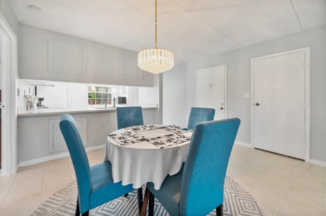 a view of a kitchen with a sink and a refrigerator
