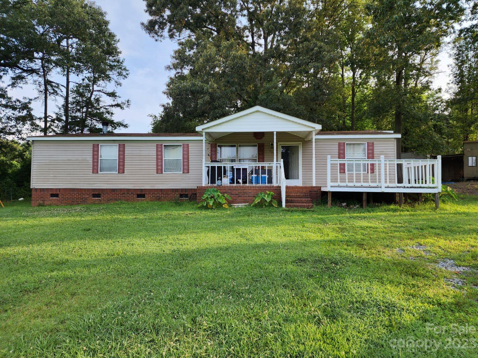201 Roxy Road Bessemer City, NC 28016 - Photo 1 of 1 a front view of a house with a garden