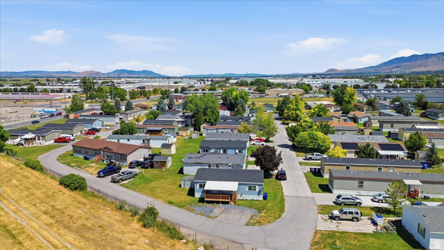 433 North 750 West Logan, UT 84321 - Photo 32 of 40 Aerial perspective showcasing a residential community with paved roads, green spaces, and a variety of homes