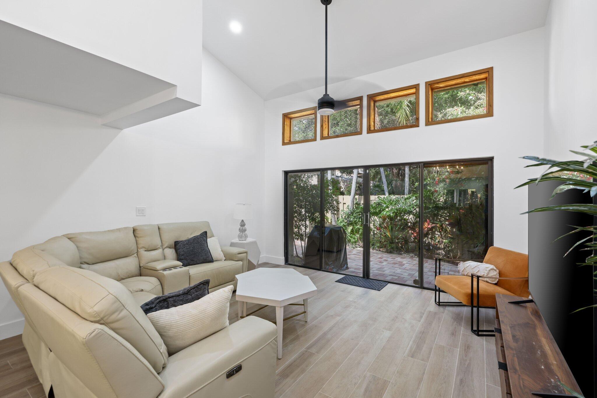 1400 Northwest 9th Avenue, Unit E34 Boca Raton, FL 33486 - Photo 14 of 46 a living room with furniture and a floor to ceiling window