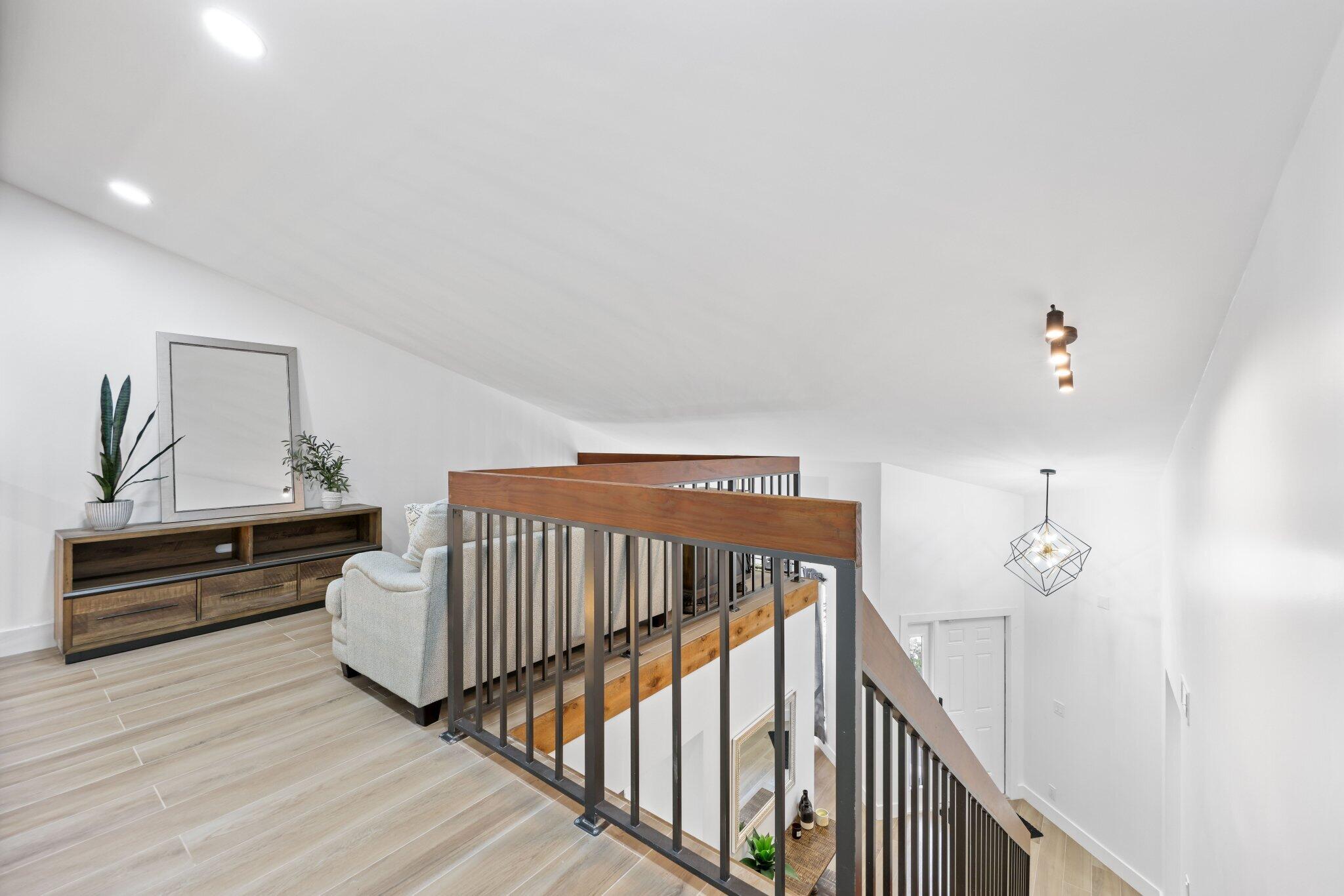 1400 Northwest 9th Avenue, Unit E34 Boca Raton, FL 33486 - Photo 18 of 46 a view of entryway livingroom and hall with wooden floor
