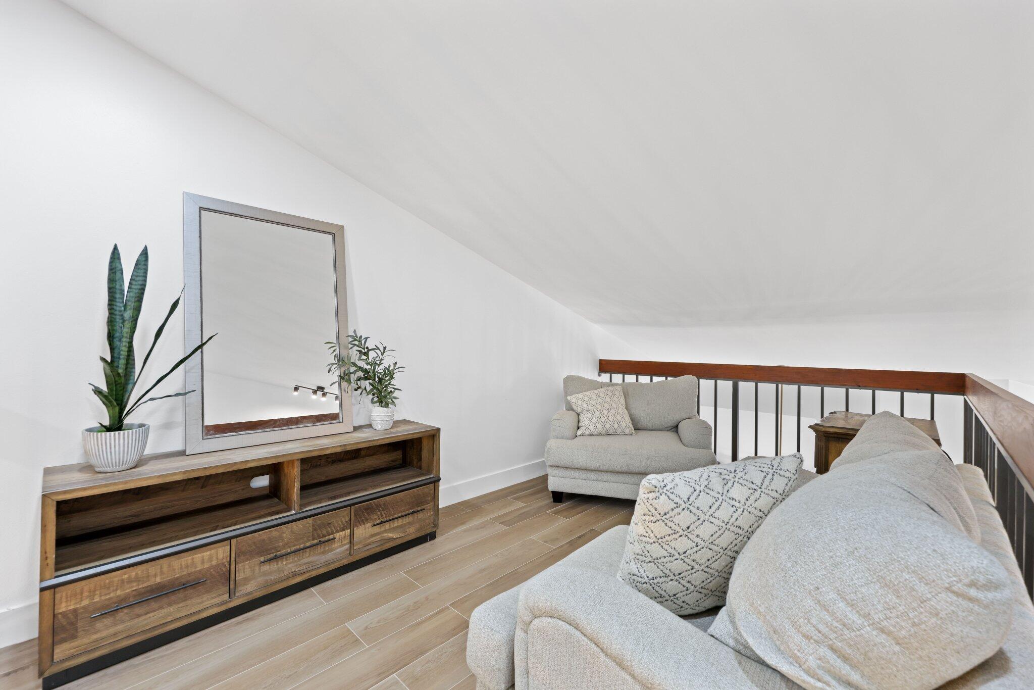 1400 Northwest 9th Avenue, Unit E34 Boca Raton, FL 33486 - Photo 19 of 46 a living room with furniture and a potted plant on the wall