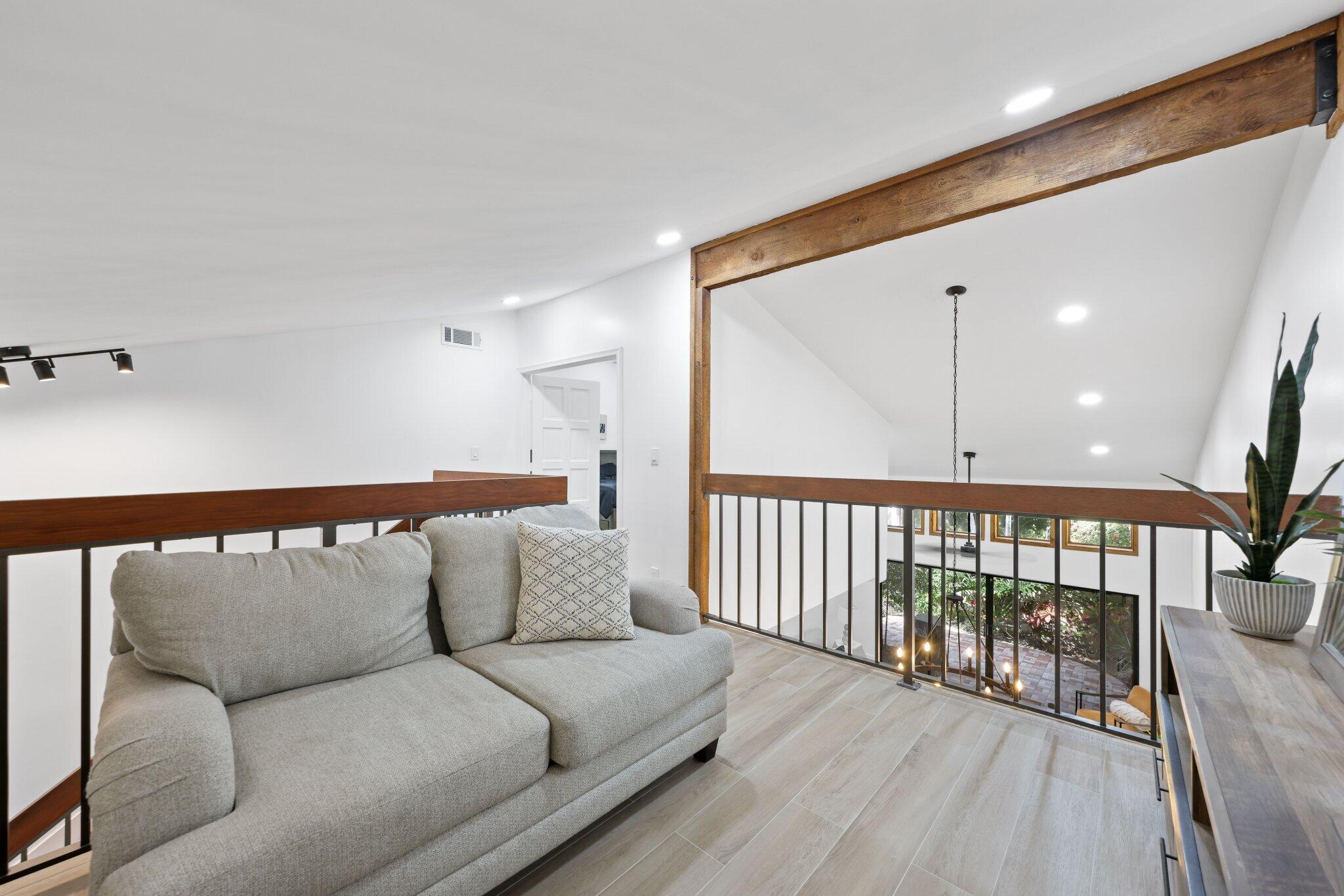 1400 Northwest 9th Avenue, Unit E34 Boca Raton, FL 33486 - Photo 20 of 46 a balcony with furniture and wooden floor