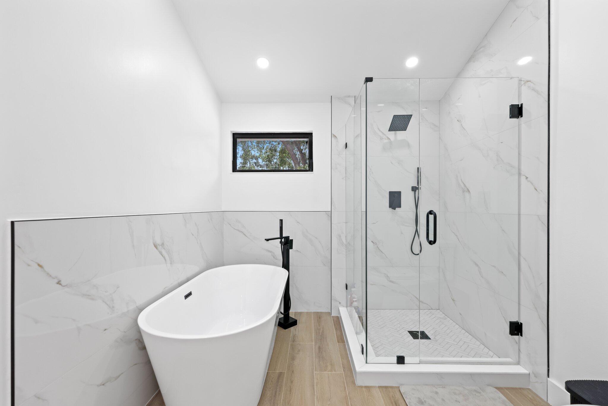 1400 Northwest 9th Avenue, Unit E34 Boca Raton, FL 33486 - Photo 25 of 46 a white bath tub sitting next to a shower