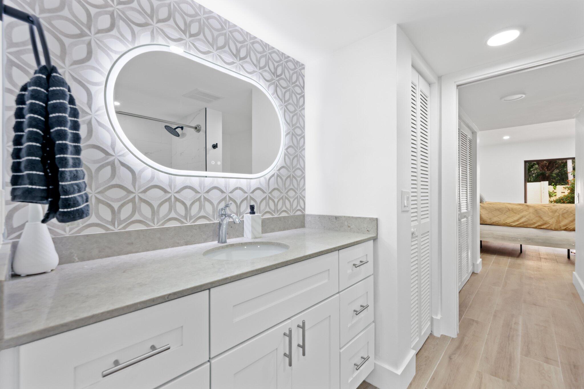 1400 Northwest 9th Avenue, Unit E34 Boca Raton, FL 33486 - Photo 28 of 46 a bathroom with a sink and a mirror