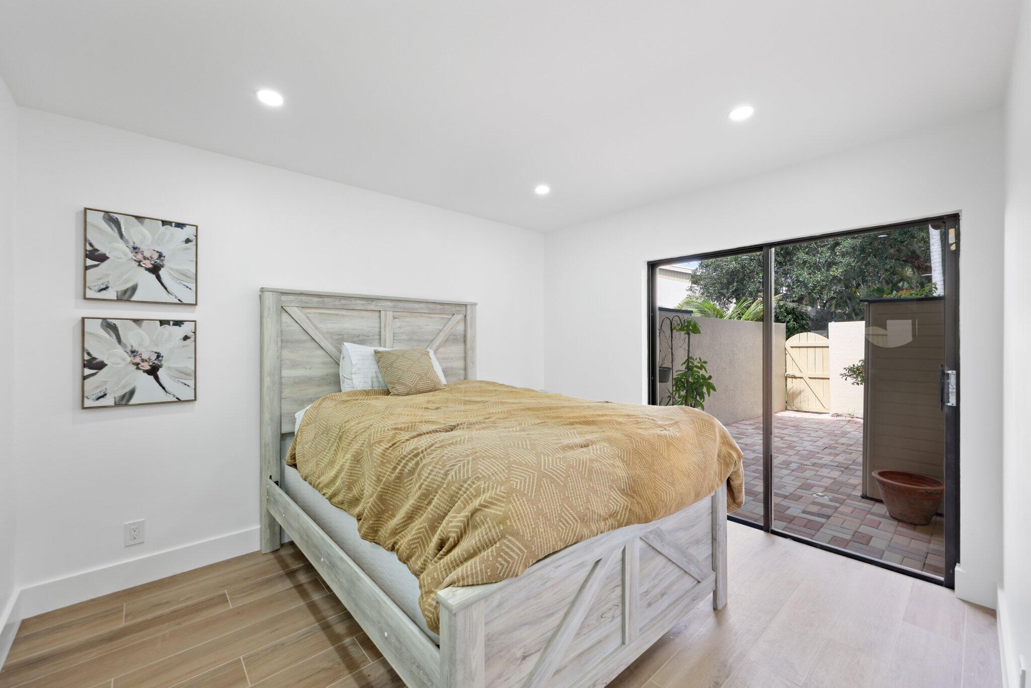 1400 Northwest 9th Avenue, Unit E34 Boca Raton, FL 33486 - Photo 31 of 46 a bed sitting in a spacious bedroom next to a window