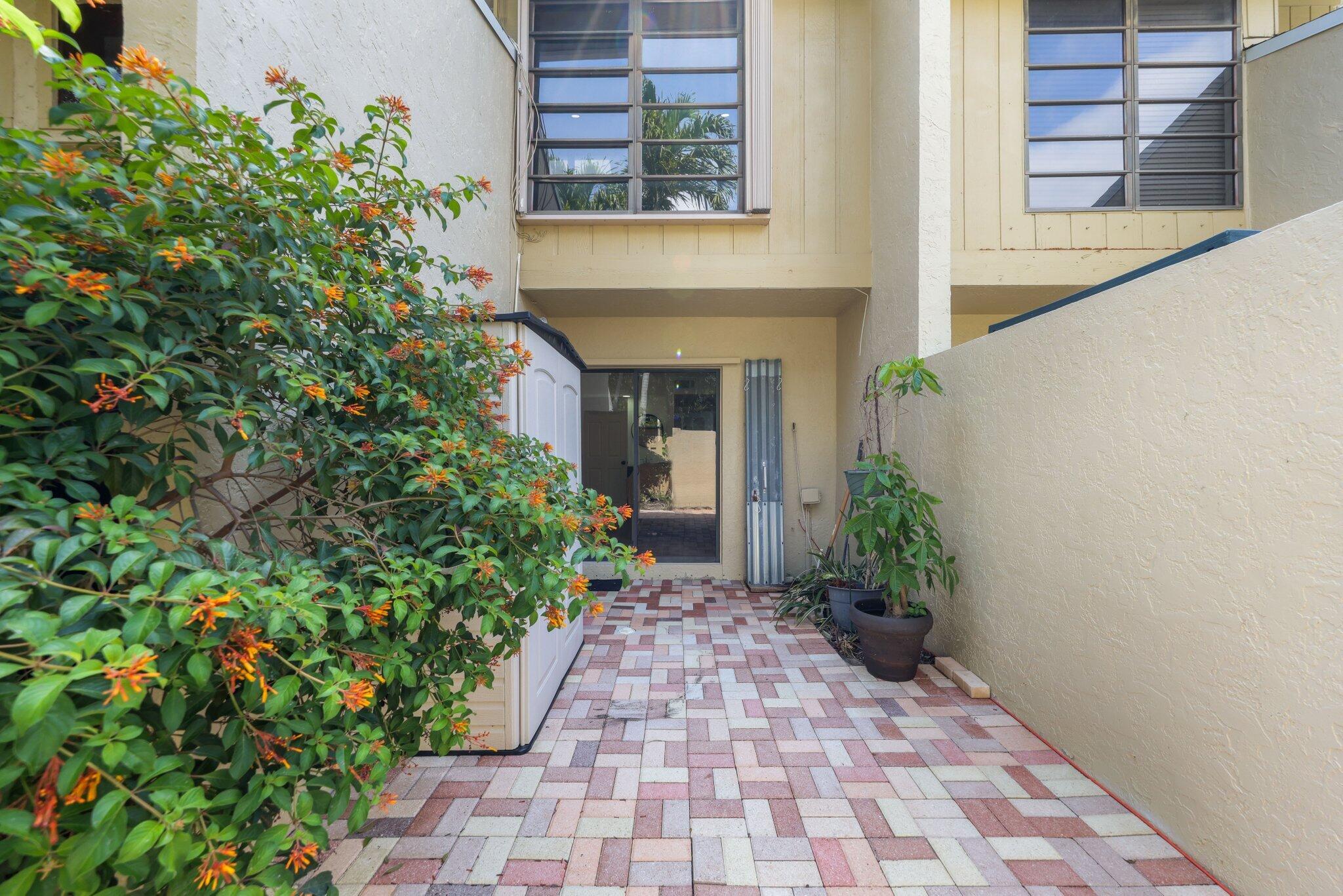 1400 Northwest 9th Avenue, Unit E34 Boca Raton, FL 33486 - Photo 33 of 46 a entryway with flower pots