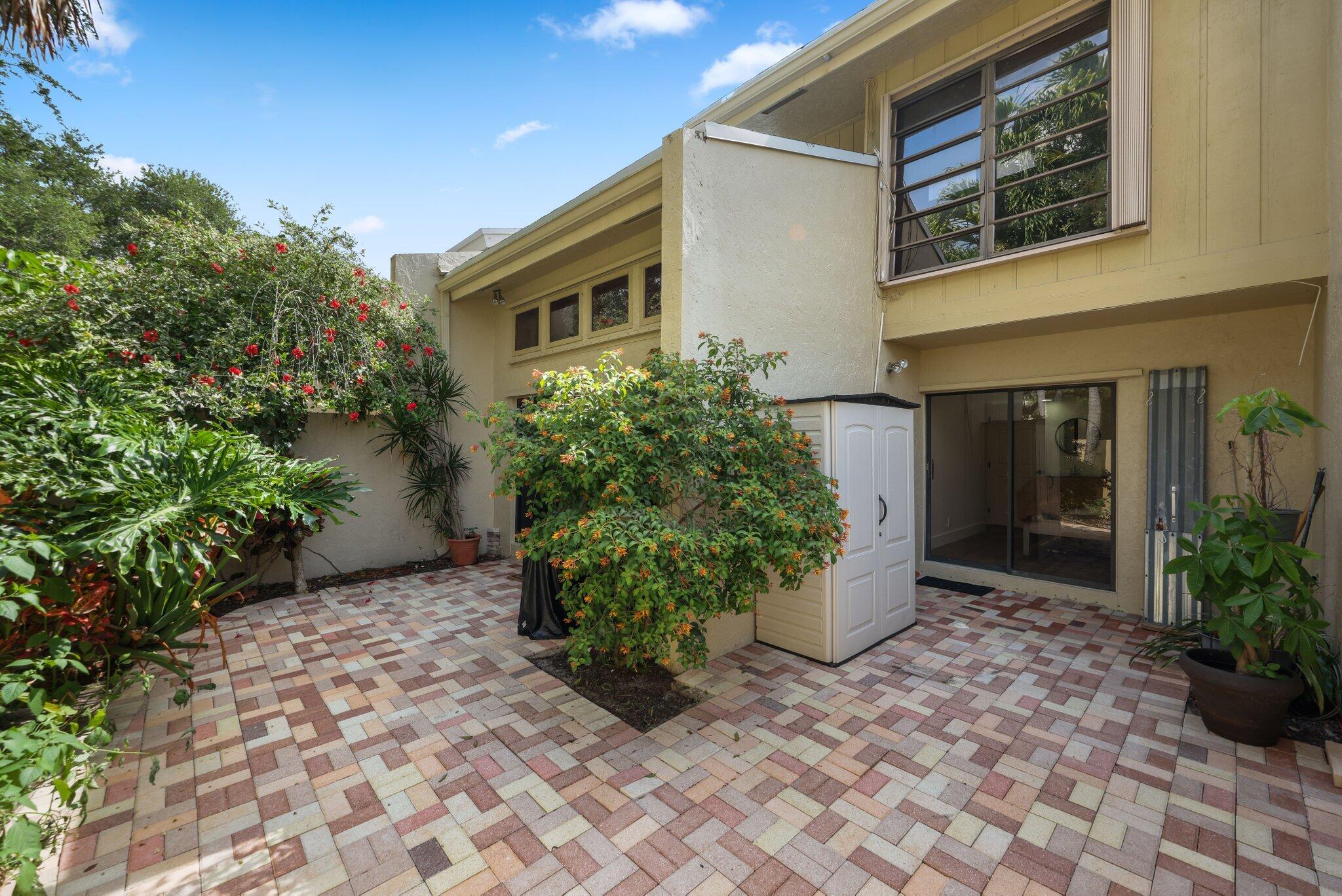 1400 Northwest 9th Avenue, Unit E34 Boca Raton, FL 33486 - Photo 36 of 46 a front view of a house with garden