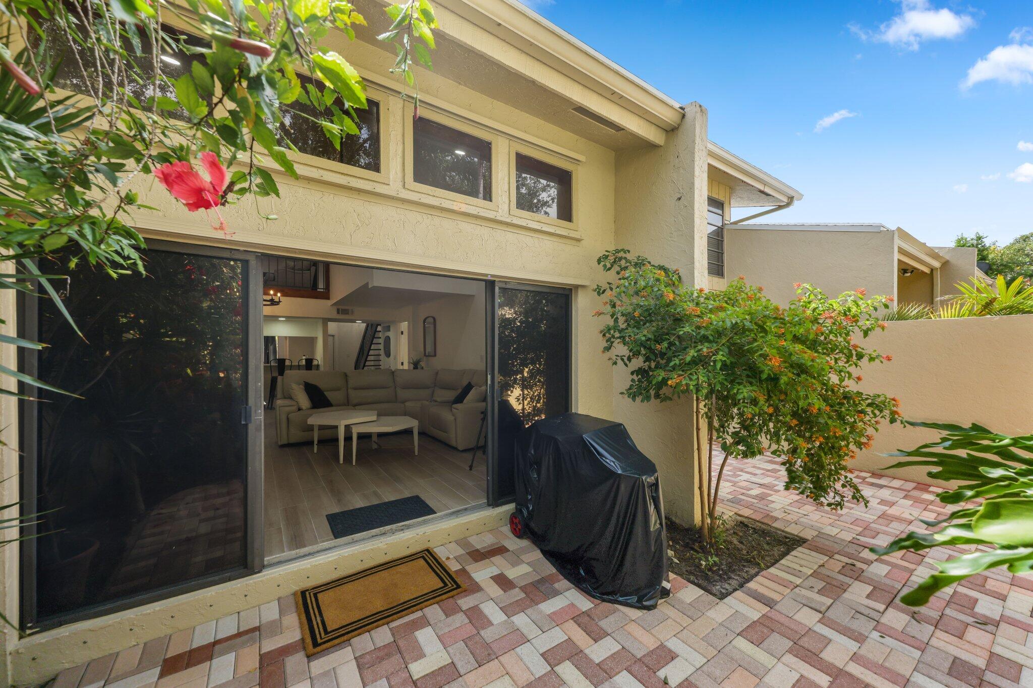 1400 Northwest 9th Avenue, Unit E34 Boca Raton, FL 33486 - Photo 37 of 46 a front view of a house with a porch