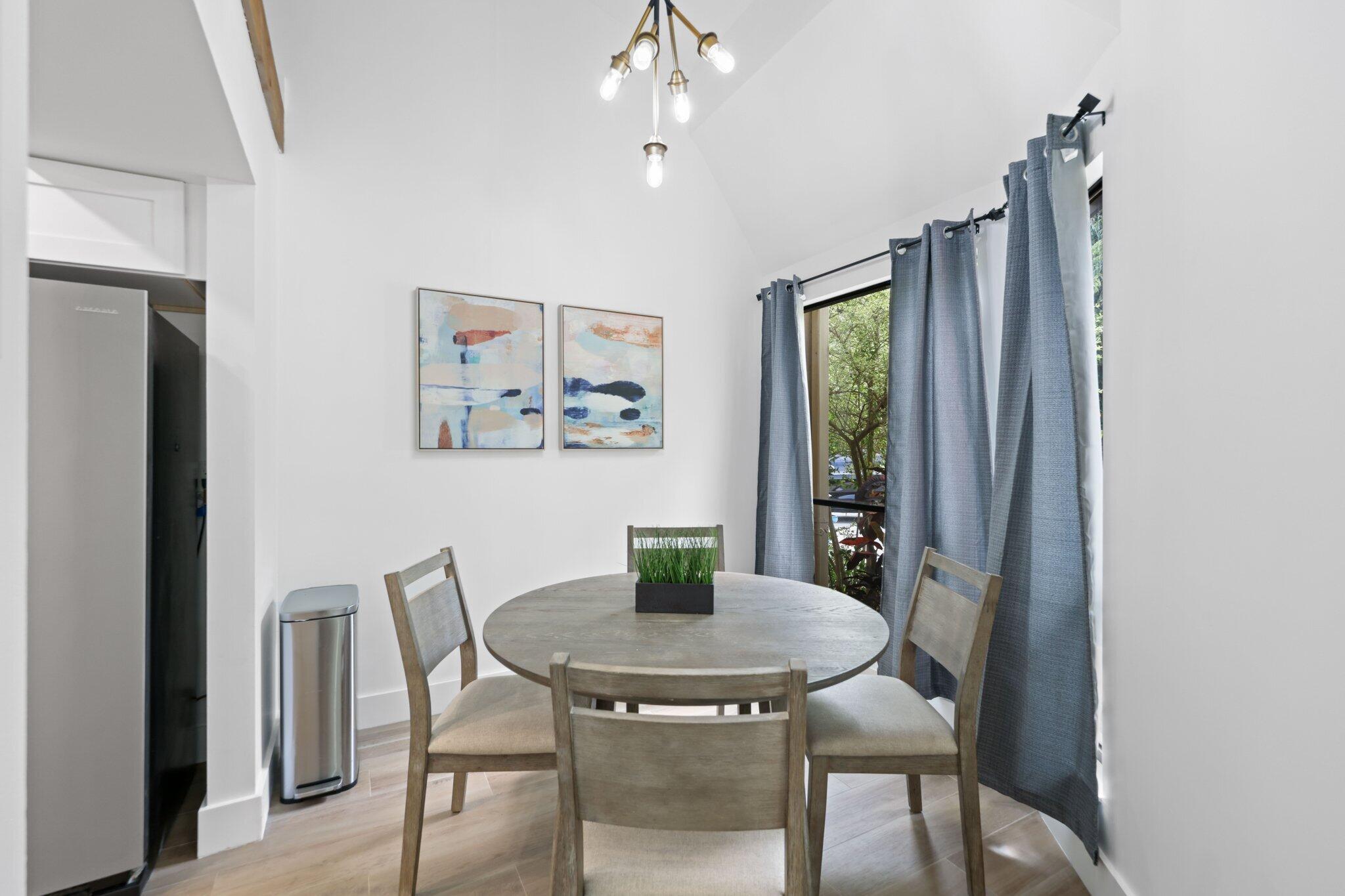1400 Northwest 9th Avenue, Unit E34 Boca Raton, FL 33486 - Photo 7 of 46 a view of a dining room with furniture window and wooden floor