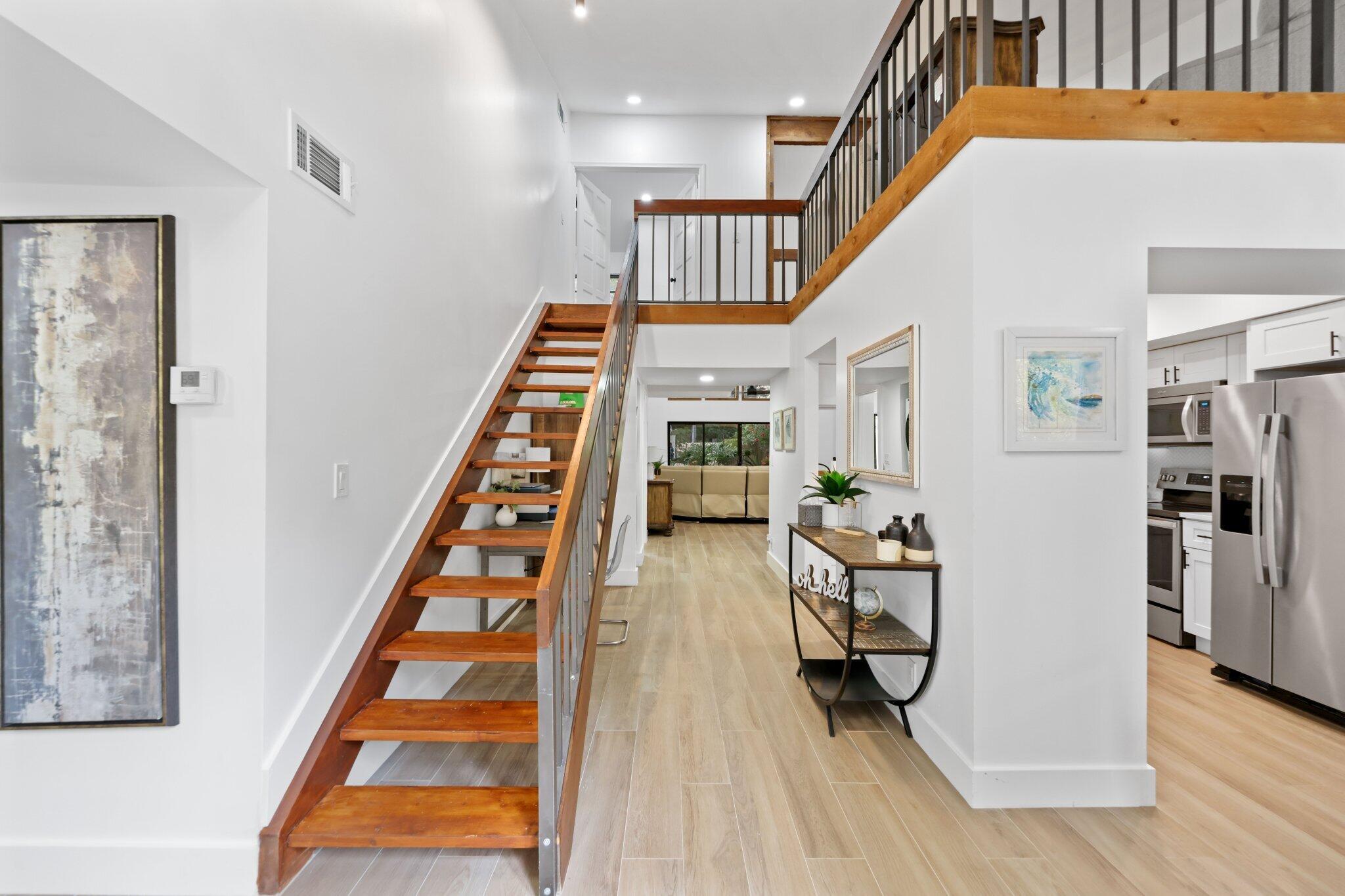 1400 Northwest 9th Avenue, Unit E34 Boca Raton, FL 33486 - Photo 8 of 46 a view of an entryway with wooden floor