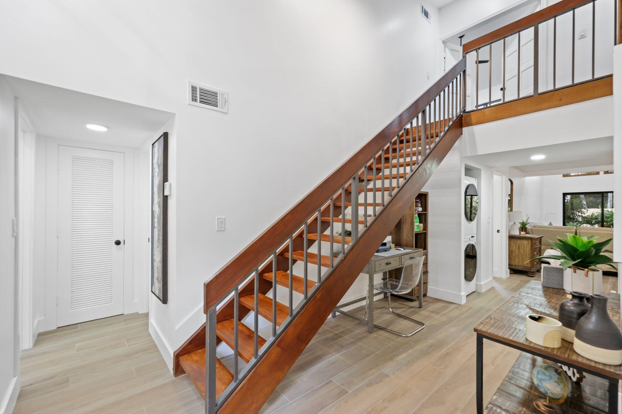 1400 Northwest 9th Avenue, Unit E34 Boca Raton, FL 33486 - Photo 9 of 46 a view of entryway with wooden floor and stairs