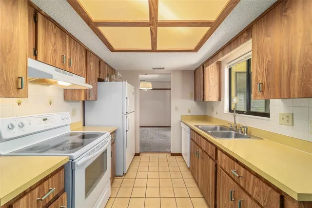 a kitchen with a sink stove and cabinets