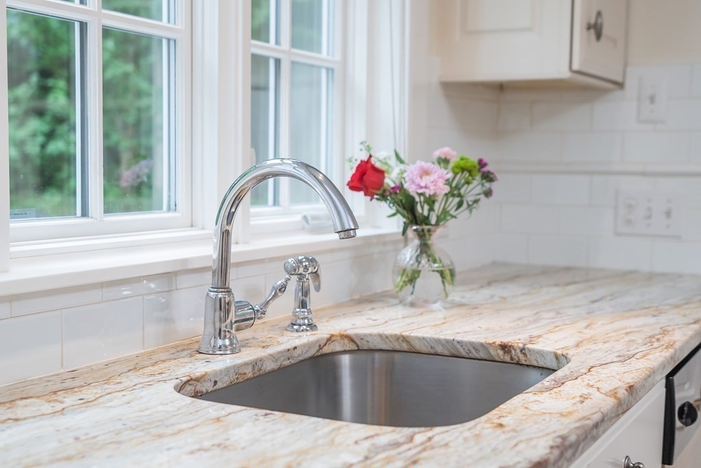 28 Dana Street Amherst, MA 01002 - Photo 15 of 41 a view of a kitchen sink a faucet a potted plant and a counter space