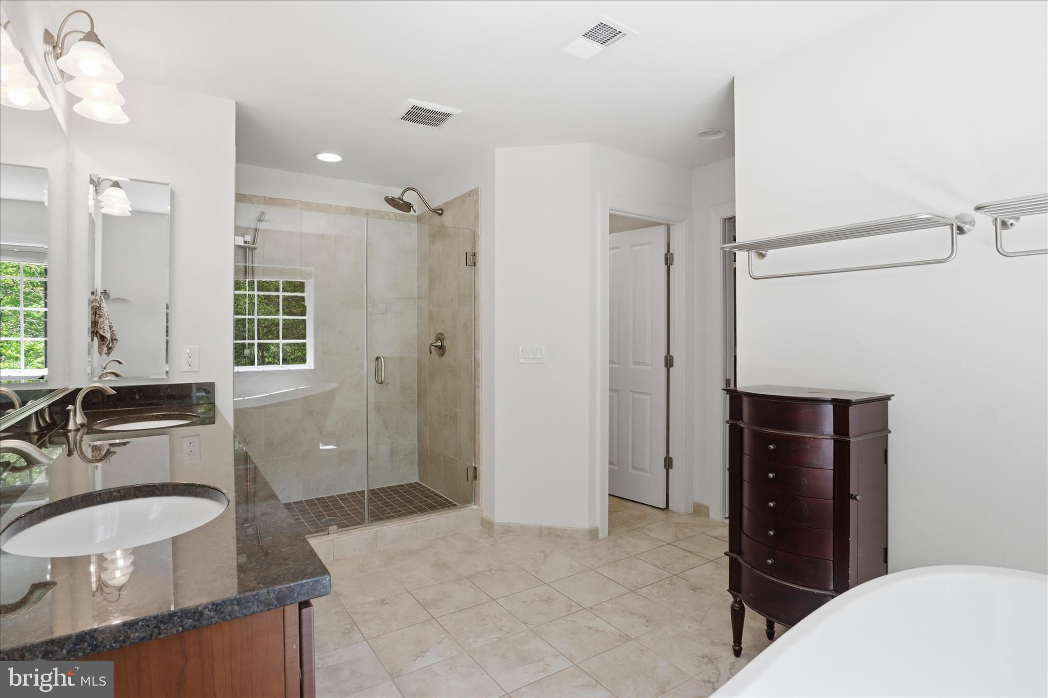 8383 Edward Carr Court Springfield, VA 22153 - Photo 28 of 57 a spacious bathroom with a tub sink and mirror