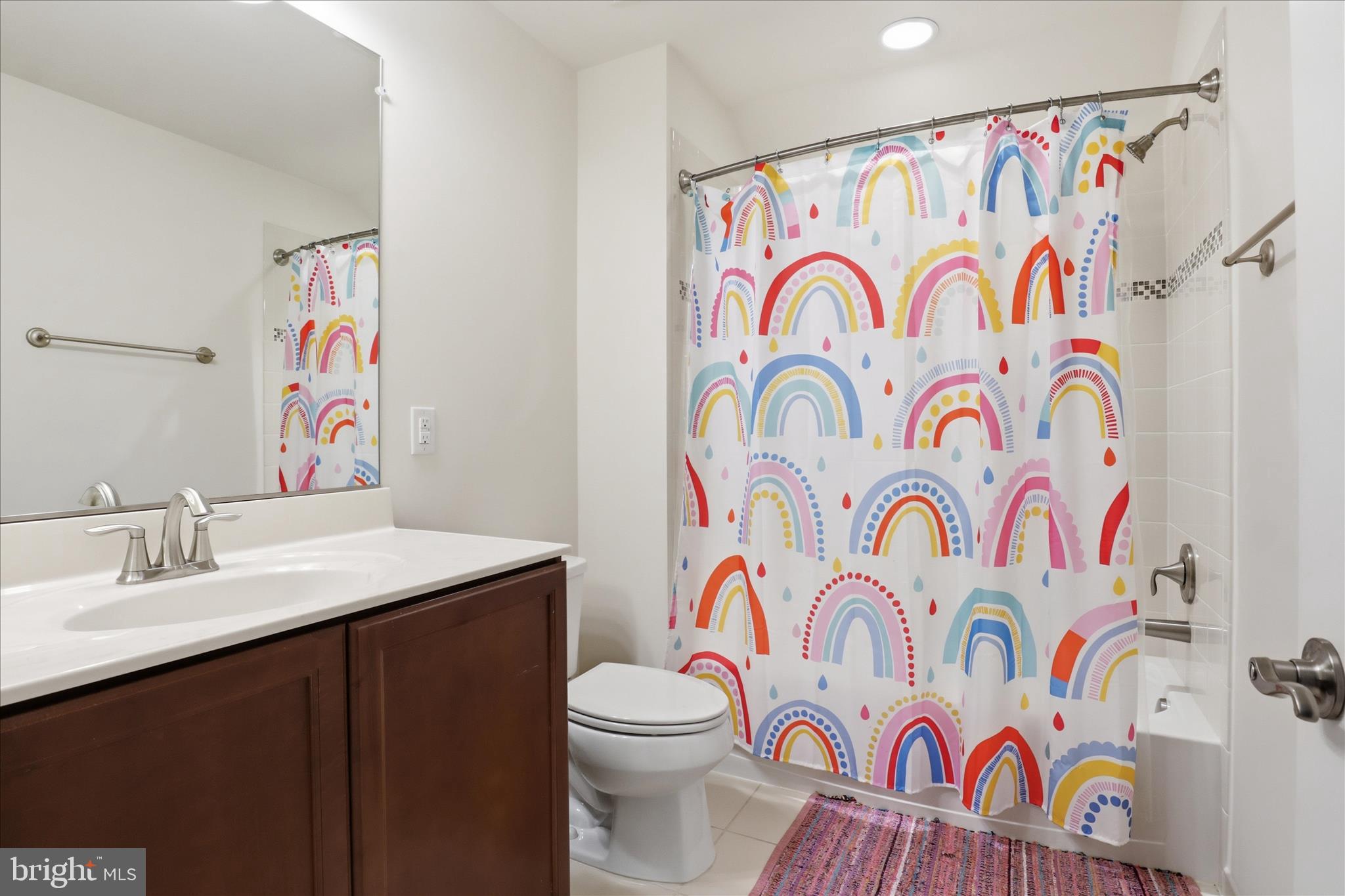8383 Edward Carr Court Springfield, VA 22153 - Photo 31 of 57 a bathroom with a sink and a shower curtain