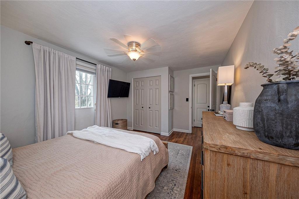 476 Haverhill Road Pittsburgh, PA 15228 - Photo 18 of 36 a spacious bedroom with a bed and a flat tv screen on dresser