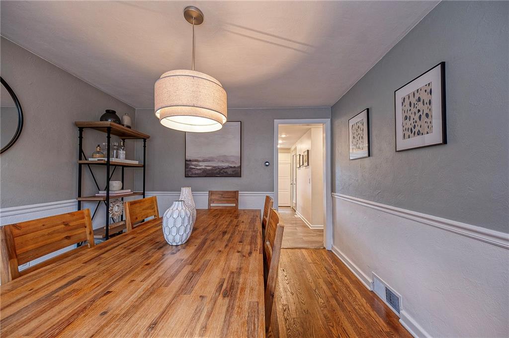 476 Haverhill Road Pittsburgh, PA 15228 - Photo 4 of 36 a dining room with wooden floor a chandelier a wooden table and chairs